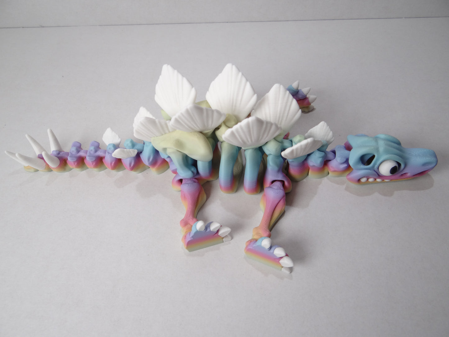 3D Printed Stegosaurus Skeleton – Fully Articulated Dinosaur Model – Glow in Dark, Sparkle Candy, Rainbow