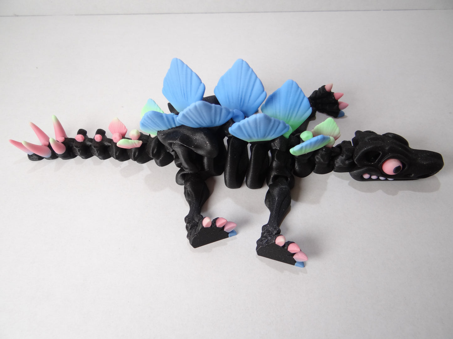 3D Printed Stegosaurus Skeleton – Fully Articulated Dinosaur Model – Glow in Dark, Sparkle Candy, Rainbow