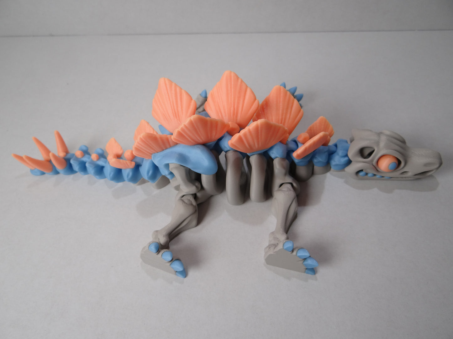 3D Printed Stegosaurus Skeleton – Fully Articulated Dinosaur Model – Glow in Dark, Sparkle Candy, Rainbow